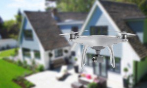 Drone quad copter with camera spying on the house and yard.